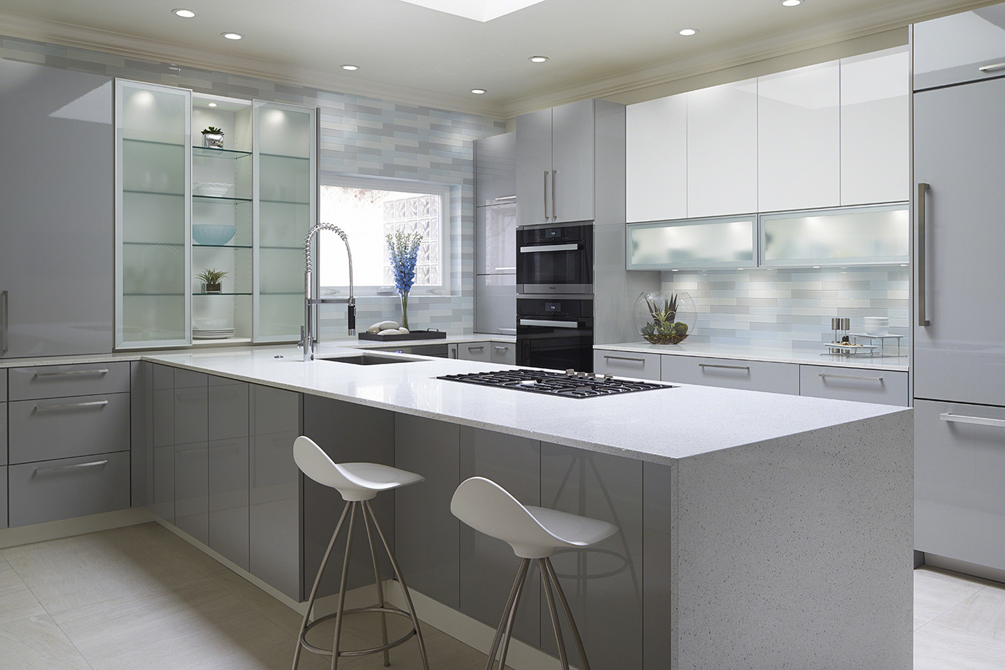 High gloss contemporary cabinets for this Norman remodel with aluminum frosted glass doors and integrated led lighting.