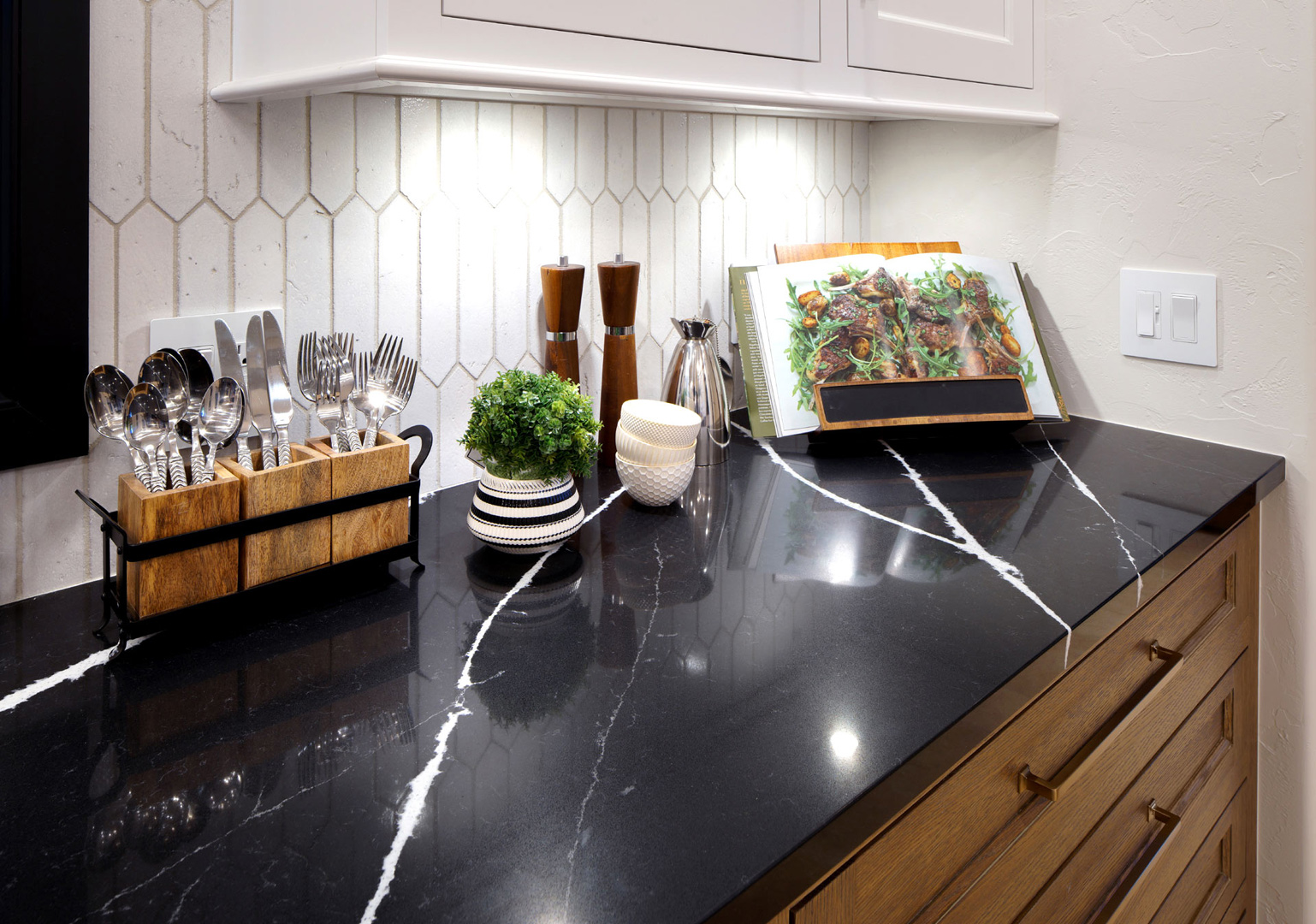 Silestone tops set atop our contemporary inset custom cabinetry in multiple finishes.