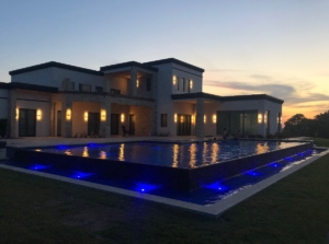 Modern ICF new construction home with infinity edge pool