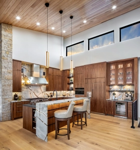 Mountain Modern Kitchen design for new construction home in Arcadia, Oklahoma. Grain matched walnut cabinets in frameless construction.