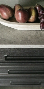 Closeup of quartz countertop on custom dark stained oak cabinetry.