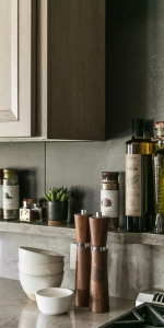 Close up of custom cabinets with quartz countertop, backsplash, and ledge.