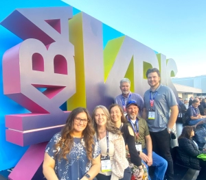 Edmond Kitchen and bath employees in front of the KBIS sign at the Kitchen and Bath Industry Show in Las Vegas.