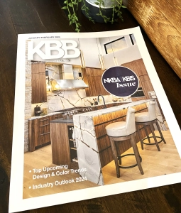 Grain matched walnut custom cabinetry, by Edmond Kitchen and Bath on the cover of the Kitchen and Bath Business Magazine, KBB, at KBIS for the Kitchen and Bath Industry Show, in Las Vegas