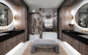 Floating Vanities with round lighted mirrors in a bathroom remodel design