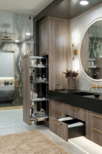 Integrated storage pull outs in our custom bathroom cabinetry created for this bath remodel