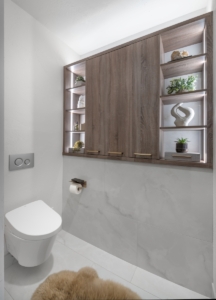 Custom cabinetry wall storage created within this toilet room for the remodel