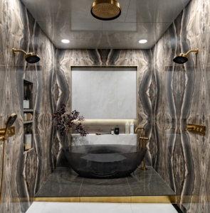 Wet room with shower, gold fixtures, and freestanding bathtub designed for this luxury bathroom remodel