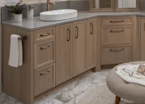 Custom cabinetry created for this high end bathroom remodel with bronze hardware and quartz counters