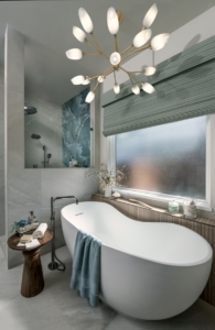 Freestanding bathtub with reeded tile ledge we created in this bath remodel design