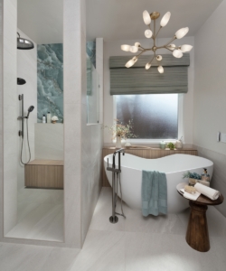 Freestanding tub with reeded tile ledge in this remodeled bathroom