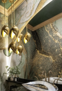 Bronze lighting in front of the curved mirror in this powder bath remodel