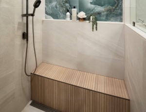 Reeded tile seat and infinity bottle niche designed and built in this shower remodel