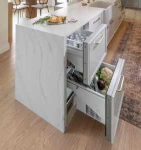 Paneled drawer refrigerator integrated into this kitchen island remodel
