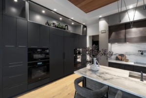 Modern kitchen oven and refrigerator cabinet wall with paneled appliances