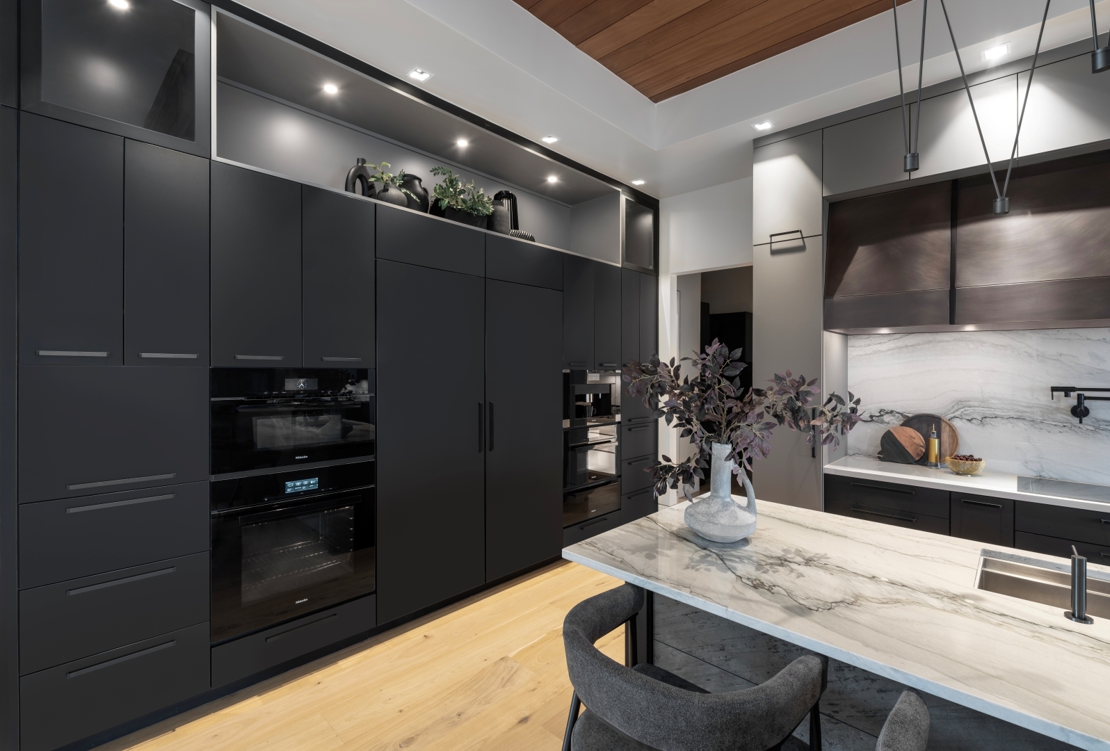 Modern kitchen oven and refrigerator cabinet wall with paneled appliances