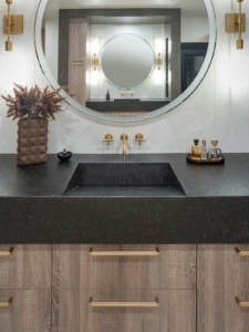 floating vanity with wall mount faucet and rounc lit mirror
