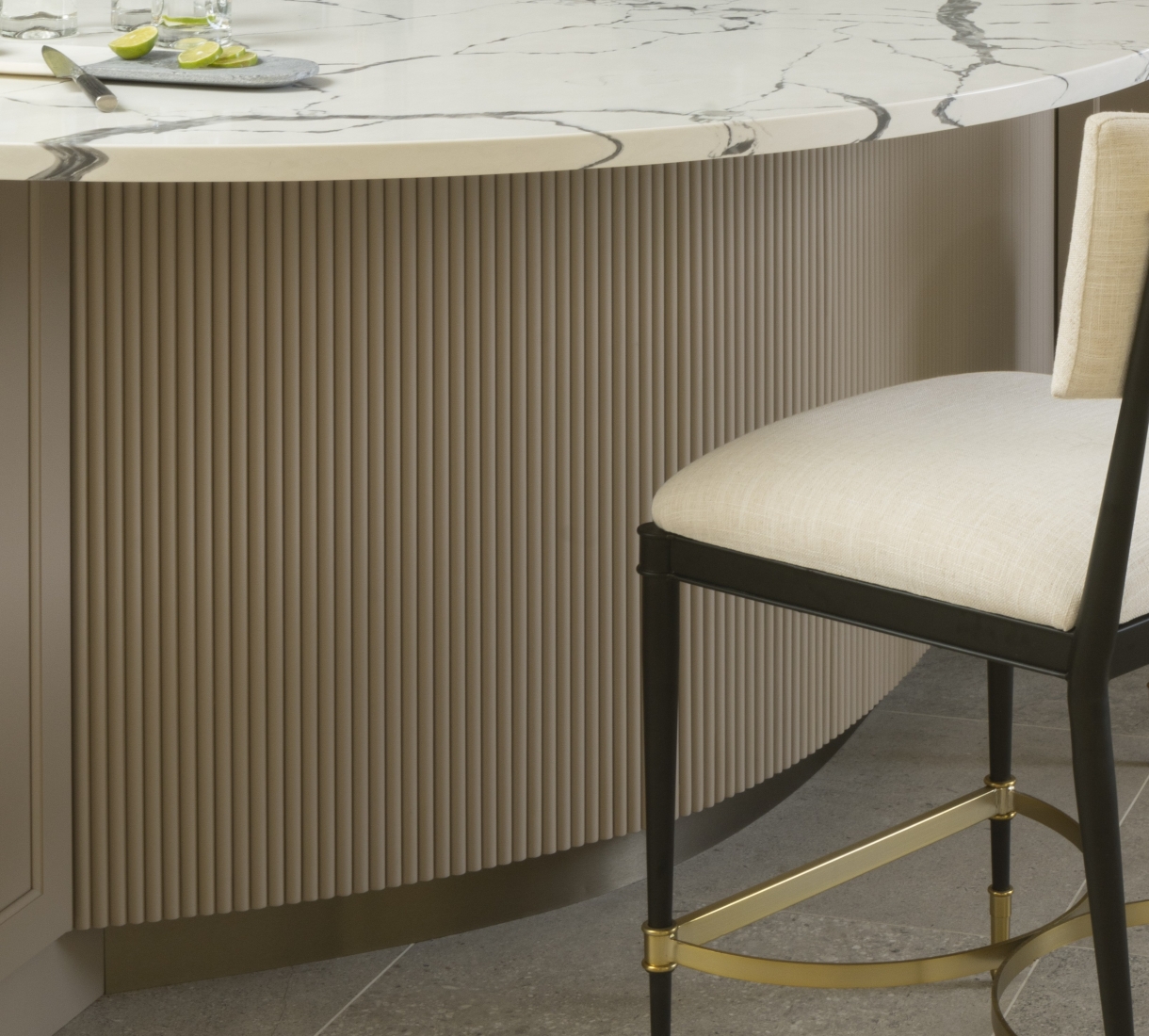 Brass toe kick beneath curved reeded panel on custom island for this OKC kitchen remodel