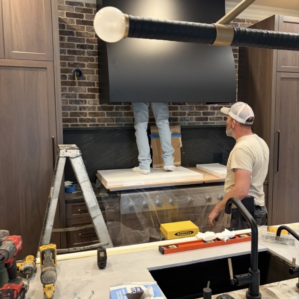 Custom vent hood being installed in this full kitchen remodel with structural wall modifications