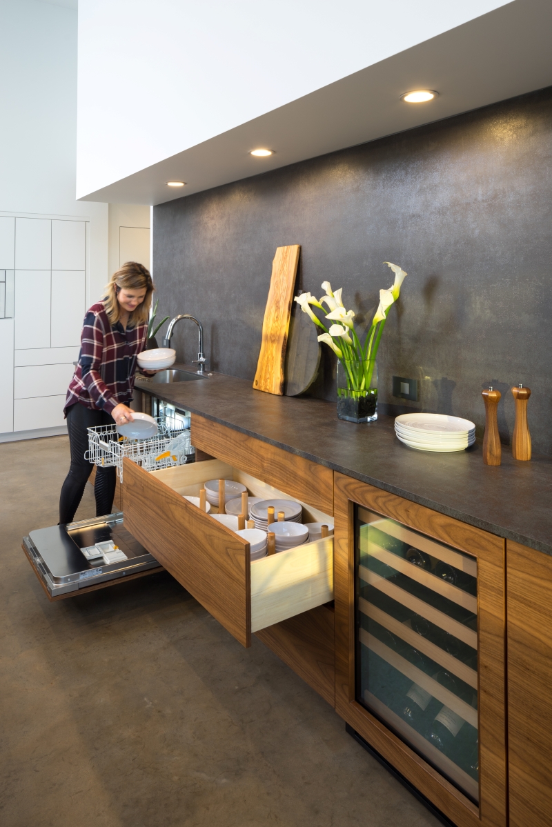 Homeowner doing the dishes in her newly built home that we created