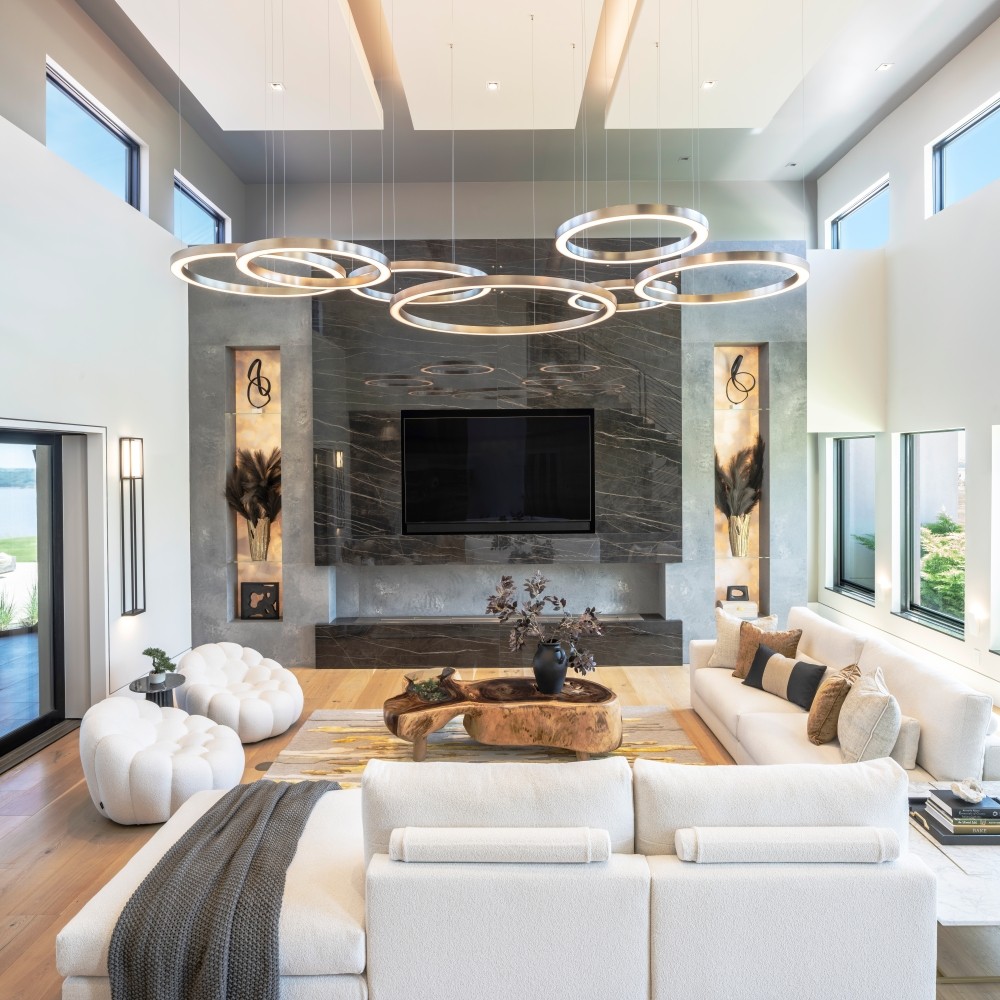 MOdern living room design by EKB with architectural ceiling details, custom lighting, and custom fireplace with backlit shelves