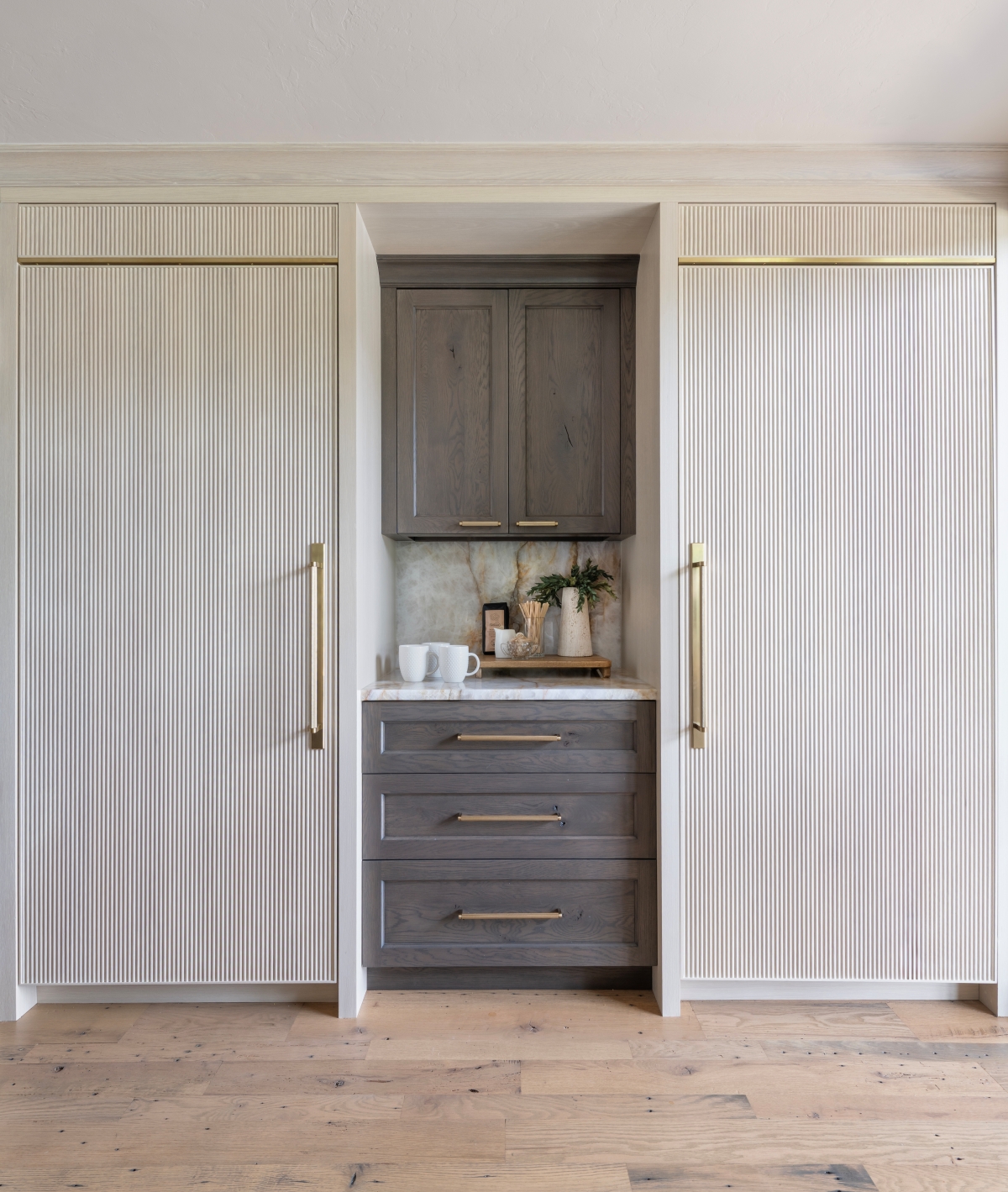 Reeded appliance panels coupled with rustic oak cabinetry highlight the cold storage wall in this Whole House redesign and build