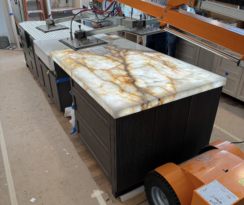 Underlit Cristallo Countertop being placed on the new island in this whole home remodel in Edmond