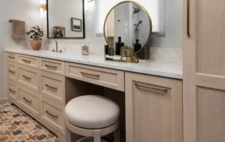 Custom light oak vanity with toe-kick lighting in remodeled guest suite bathroom