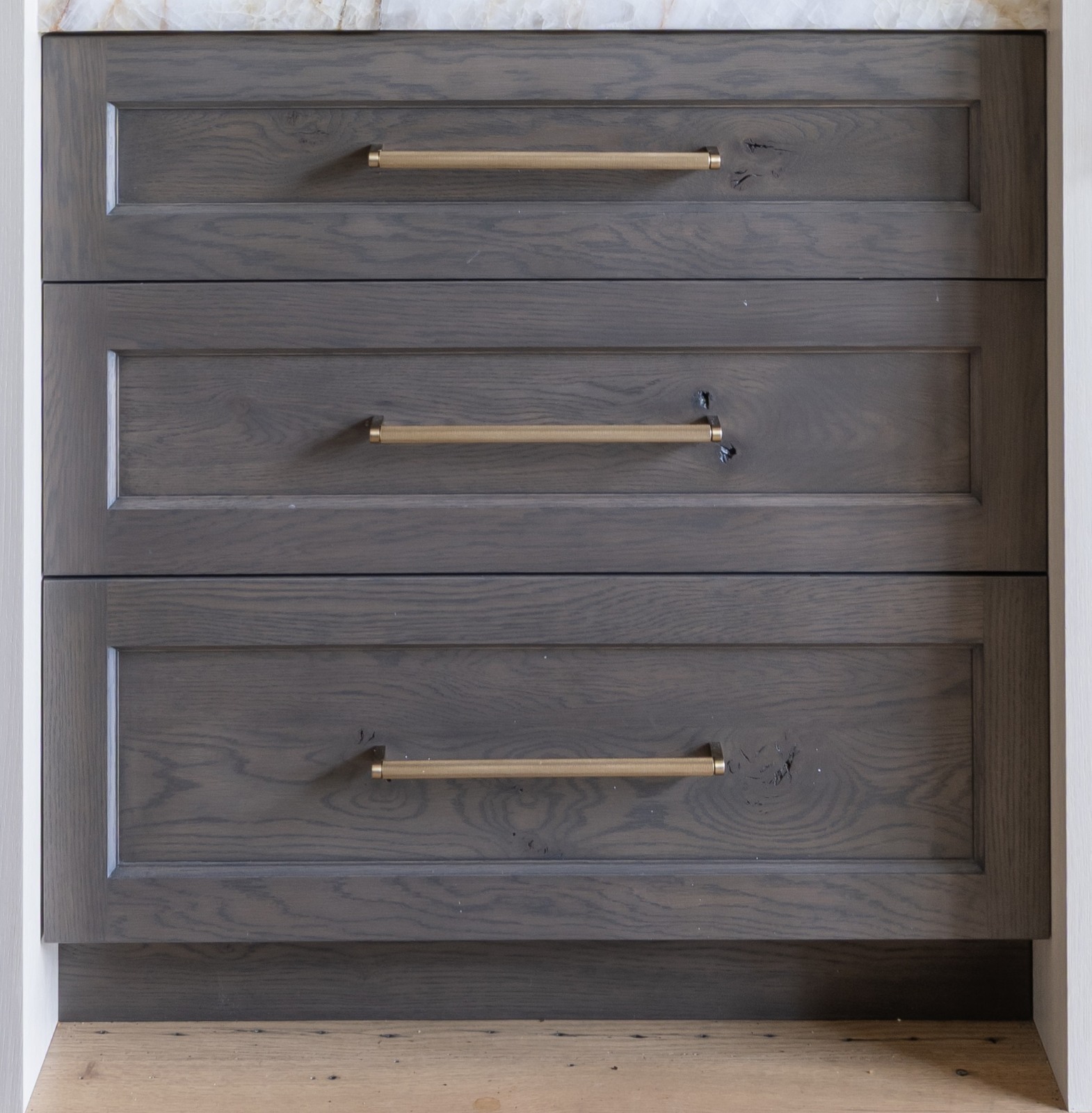 Edmond-kitchen-remodel-knotty-oak-cabinetry-detail Knotty oak triple drawer bank with gold hardware designed for this kitchen.
