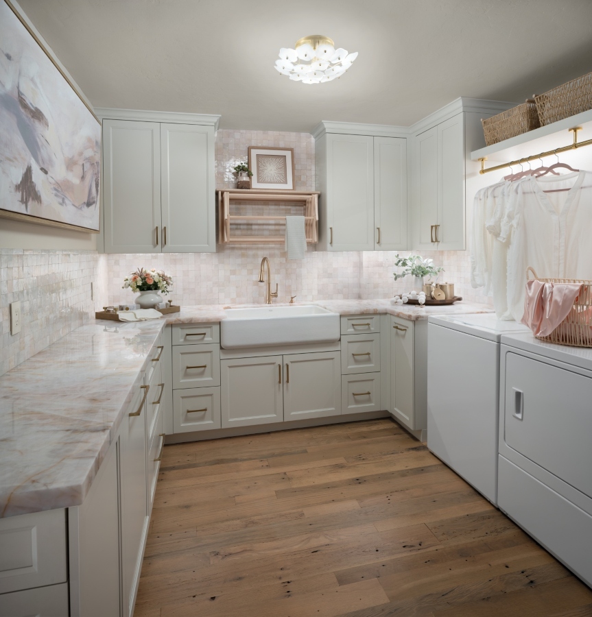 Remodeled and right sized laundry room with illuminated hanging rod, drying rack at sink, and Pink Cristallo countertops