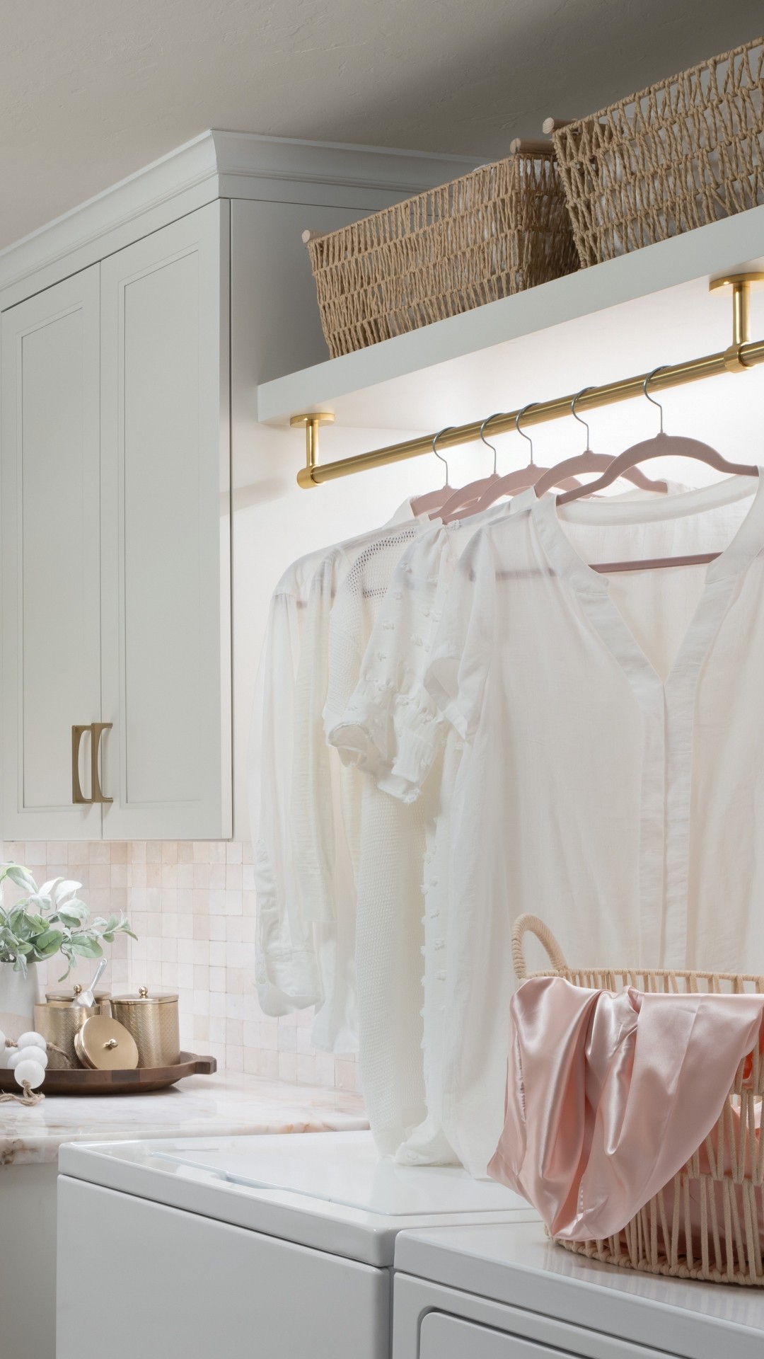 Laundry-design-shelf-with-integrated-lighting-and-hanging-rod Custom floating shelf with hanging rod and integrated lighting in this laundry room remodel in Edmond