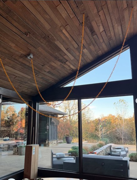 Testing the placement of the swoop light fixture for precision in this whole home remodel.